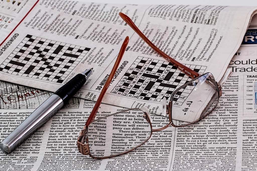 Crossword puzzle pencil hand