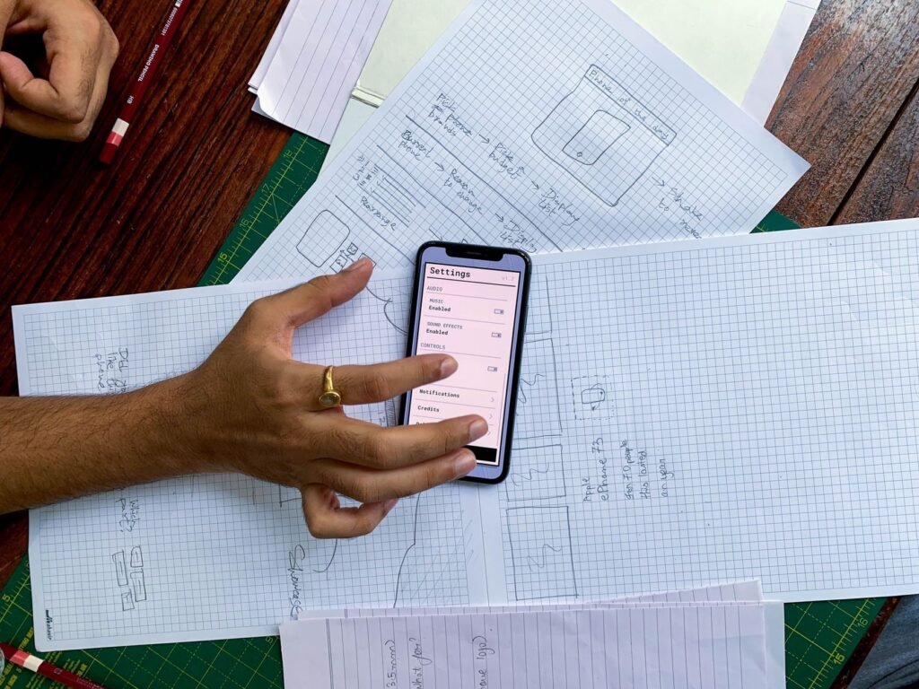 A hand tapping a settings menu with on off toggles on a smartphone