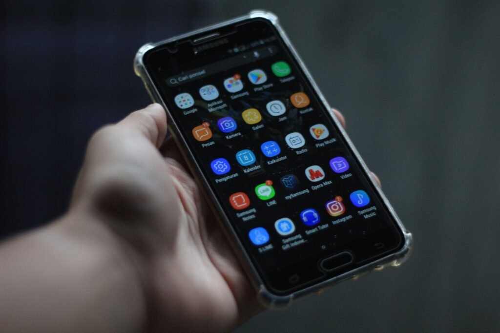 Close-up of a smartphone showcasing various mobile applications on its display