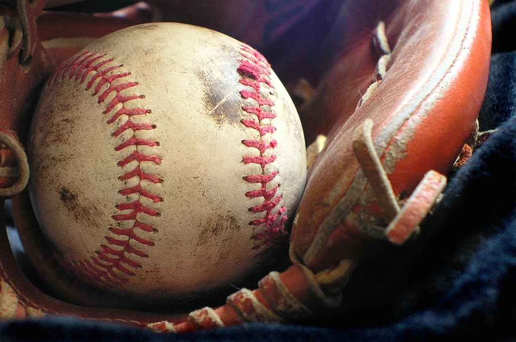 Baseball and glove on grass