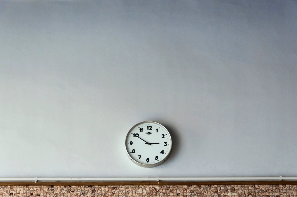 Round analog clock white wall