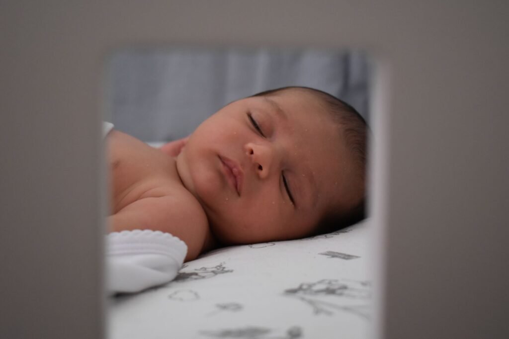 A serene image of a sleeping baby lying peacefully indoors. Captured in soft and gentle lighting.
