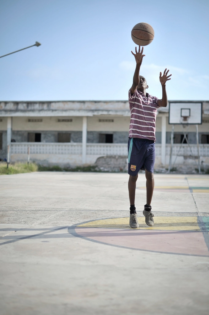 Boy practices his shot basketball